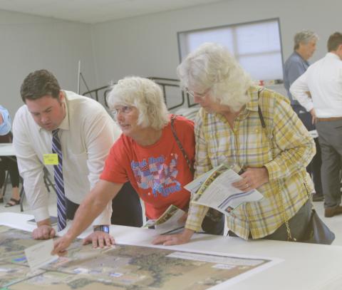 Justin Fairman (from left), an FDOT employee, listens as Elaine Reeves and Jeanette Lee share their concerns about congested traffic patterns in the Ellisville area near Intestate 75 on Monday afternoon. (TONY BRITT/Lake City Reporter)