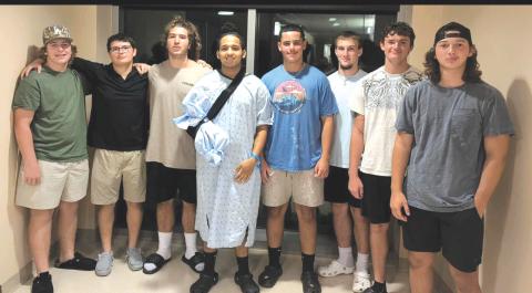 Davic Kasper (middle) was involved in a side-by-side ATV crash back in August, necessitating the amputation of his right hand. A set of fundraisers are being organized to help cover Kasper’s medical costs. (COURTESY)