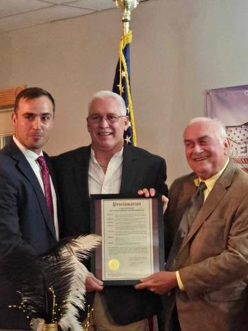 Lake City Elks Lodge 893 members Noah Walker (from left), Exalted Ruler Bill Roberts and Stephen Witt show off a proclamation declaring Nov. 9, 2024, as Lake City Elks Lodge 893 Anniversary Celebration Day. The lodge held a celebration on Saturday night acknowledging 120 years of providing service to Columbia County. (COURTESY)