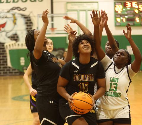 Columbia forward Jolena Gardner grabs a rebound in traffic during Friday’s game against Suwannee. (PAUL BUCHANAN/Lake City Reporter)