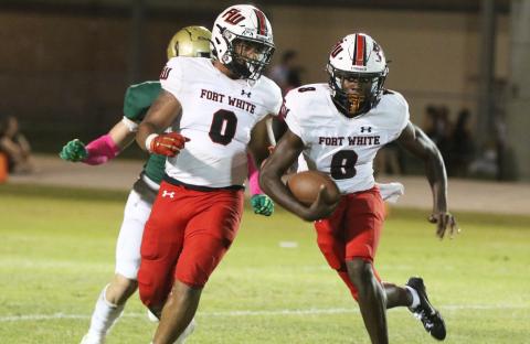 Fort White quarterback Jayden Jackson (8) scrambles up the field alongside running back Lecosta Byrd (0) against Fleming Island on Nov. 1. (MORGAN MCMULLEN/Lake City Reporter)