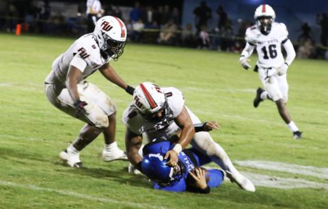 Fort White linebackers Lecosta Byrd (0) and Darion Brinson collapse on Jay quarterback Hayden Morris during last week’s Class Rural playoff game. (MORGAN MCMULLEN/Lake City Reporter)