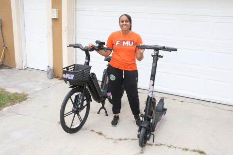 Erica Mayo shows off the e-Fly bike and scooter models that will be used in her upcoming rental business that’ll debut in downtown Lake City in late December. (MORGAN MCMULLEN/Lake City Reporter)