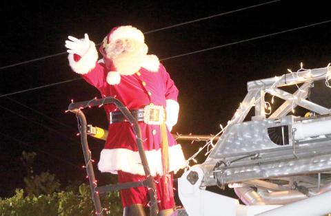 Santa Claus waves to spectators during last year’s Rotary Club of Lake City Christmas parade. (FILE)