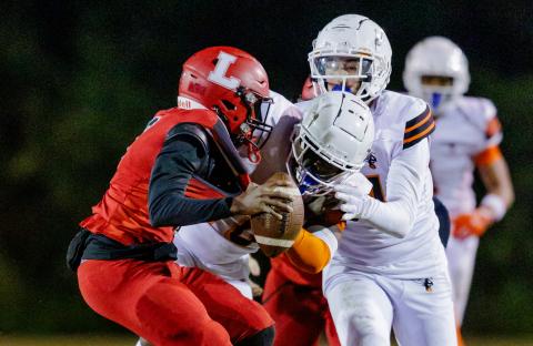 Lafayette quarterback Tywan Williamson is sacked by Hawthorne defensive tackle Kyler Ingram during the Class Rural quarterfinals on Friday. (JACK HOWDESHELL/Lake City Reporter)