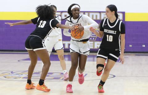 Columbia guard Ayesha Broxey tries to pass out of a double team from Buchholz guards Kennedy Wyckoff (13) and Isabella Alexander (10) on Wednesday night. (BRENT KUYKENDALL/Lake City Reporter)