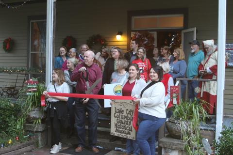 Members of the Lake City-Columbia County Historical Museum prep to cut the ribbon during the museum’s grand re-opening event Thursday. (TONY BRITT/Lake City Reporter)