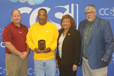 Columbia School District Director of Transportation Daniel Taylor (from left), Clarence Tucker, School Board Member Narri Smith and Superintendent Keith Couey pose after Tucker was honored for saving a student’s life with CPR. (TONY BRITT/Lake City Reporter)