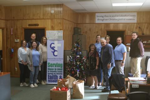 The Christian Service Center and volunteers from Gallagher Insurance provided food to nearly 200 people as part of the agency’s annual Christmas Basket distribution. (TONY BRITT/Lake City Reporter)