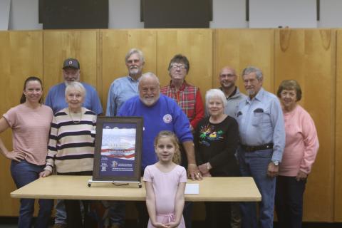 Members of the Blue-Grey Army committee and staff unveiled the 2025 Olusee Festival poster Monday evening at the Columbia County Public Library. Pictured are, in front, Annie Buzzella; second row, from left, Brooke Frye, Faye Warren, Tony Buzzella, Ann Brown; back row, from left, Randy Sweet, Tom Coleman, Patty Melgaard, Matt Johns, Bud Thayer and Ginny Thayer. (TONY BRITT/Lake City Reporter)