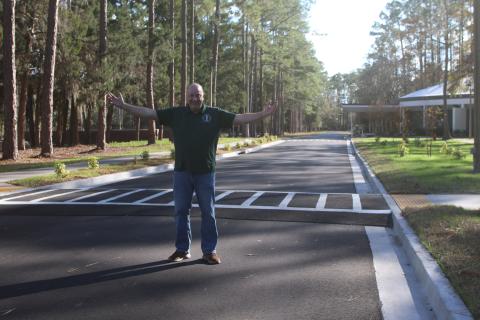 Florida Gateway College President Larry Barrett stands on the finished roadway on the college campus that runs past the Howard Center. The road was opened a few weeks ago. (TONY BRITT/Lake City Reporter)