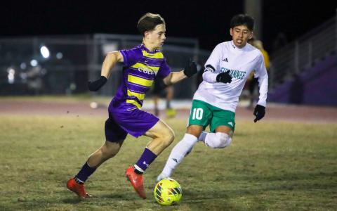 Columbia's Cody Bass dribbles up the field past Suwannee's Denzel Yaxon on Wednesday night. (BRENT KUYKENDALL/Lake City Reporter)
