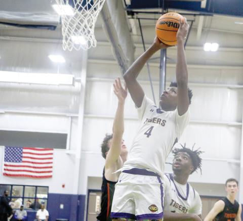 Columbia guard Shaheed White rises up past a Trenton defender for a layup Friday at the Hitchcock’s Challenge in Alachua. (MORGAN MCMULLEN/Lake City Reporter)