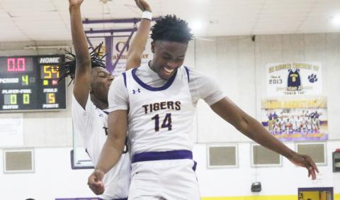Columbia guard Gavin Broomfield (left) and forward Xavier Collins (14) celebrate after the Tigers rallied from a 13-point deficit to defeat Buchholz 54-49 on Tuesday night. (JORDAN KROEGER/Lake City Reporter)