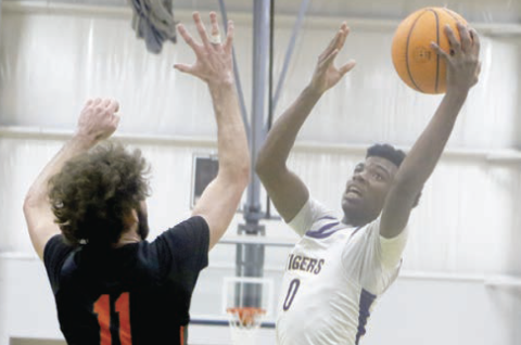Columbia guard Murkail Cray goes up for a shot over Trenton’s Nathan Ridgell during Friday's game at the Hitchcock’s Challenge. (MORGAN MCMULLEN/Lake City Reporter)