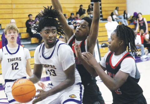 Columbia forward Zavian Douglas looks to pass as he's double teamed by The Rock on Nov. 19. (JORDAN KROEGER/Lake City Reporter)