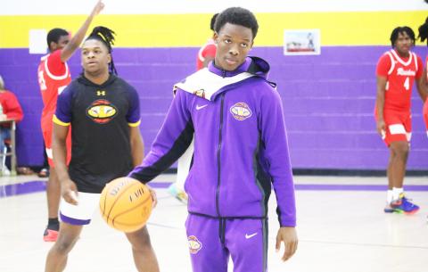 Columbia guard Marlin Haywood helps the Tigers warm up prior to Friday’s game against Santa Fe. Haywood has transferred back to Columbia after playing football at Bradford this fall. (JORDAN KROEGER/Lake City Reporter)