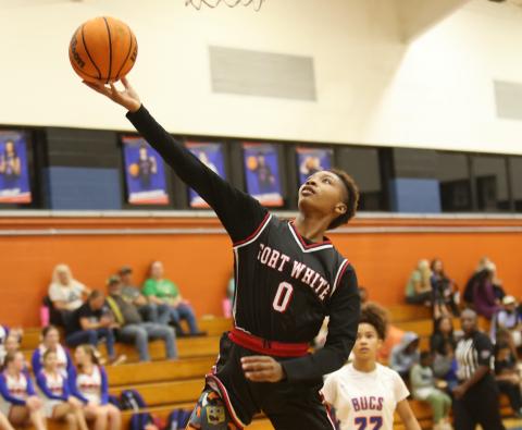 Fort White forward Isreal Hart makes a layup against Branford on Tuesday night. (PAUL BUCHANAN/Lake City Reporter)
