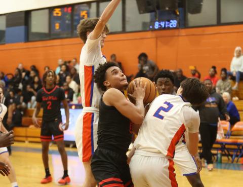 Fort White guard Tafari Moe fights to get off a shot amid the Branford defense on Tuesday night. (PAUL BUCHANAN/Lake City Reporter)