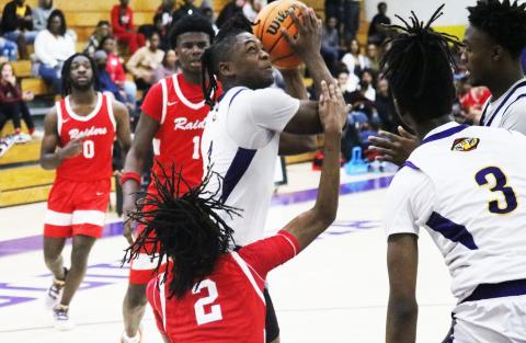 Columbia guard Zamarion Jones is fouled by Santa Fe guard Cedric Collins while making the go-ahead layup in the final minute of Friday’s 62-57 win. (JORDAN KROEGER/Lake City Reporter)
