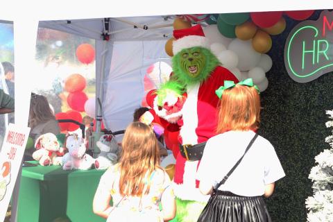 The Grinch speaks with a pair of girls at last year’s Christmas in Columbia Holiday Market. (FILE)