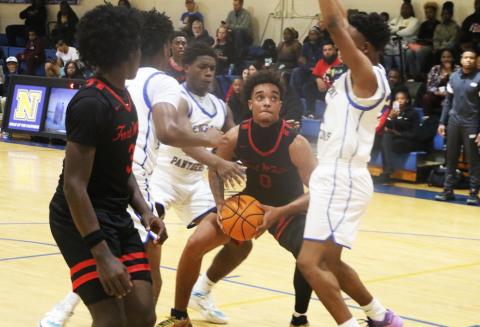Fort White guard Tafari Moe is bracketed by Newberry defenders during Friday’s 59-45 loss. (MORGAN MCMULLEN/Lake City Reporter)