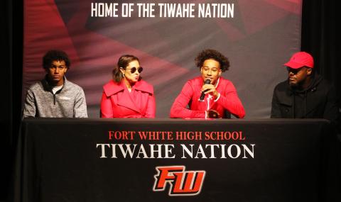 Fort White receiver Mike Peterson Jr. (middle left) speaks during his signing ceremony Wednesday alongside his brother, Gavin (left) mother, Chantal (middle right), and his father, Mike (right). Peterson signed his letter of intent to play collegiately at Arkansas State. (MORGAN MCMULLEN/Lake City Reporter)