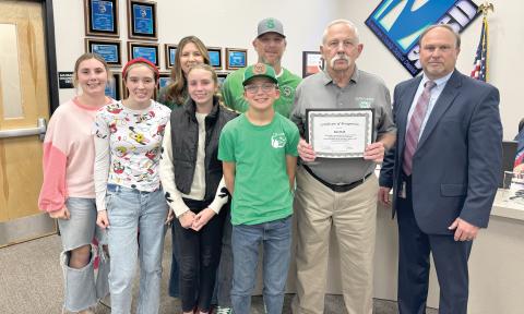Former Suwannee High track coach Ron Hall was recognized by the Suwannee County School Board at its Tuesday meeting. The district is naming the renovated SHS track complex after Hall, who coached there for 20 years and won the school’s only state track title. Joining Hall are grandchildren McKenna Burnett (front row, from left), Kynzie Hall, Claire Burnett and Kooper Hall; children Casi Burnett (back row, from left) and Kyler Hall and Superintendent Ronnie Gray. (COURTESY)