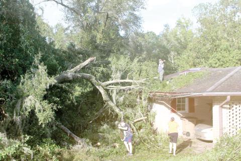 Columbia County residents survey the damage to a home in the wake of Hurricane Helene. Helene made landfall on Sept. 26 before knocking out power for more than 99% of Columbia County residents. (FILE)