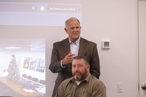 Former State Rep. Bobby Payne (top) speaks during the NFWUA meeting Wednesday in front of Leo Mobley, a board member. (JAMIE WACHTER/Lake City Reporter)