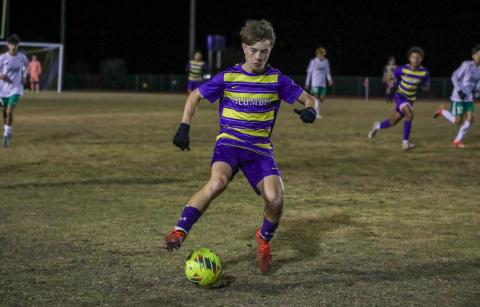 Columbia's Cody Bass dribbles up the field against Suwannee on Dec. 11. (BRENT KUYKENDALL/Lake City Reporter)