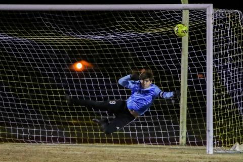 Suwannee goalkeeper AJ Hitt dives to try and save a shot against Columbia on Dec. 11. (BRENT KUYKENDALL/Lake City Reporter)