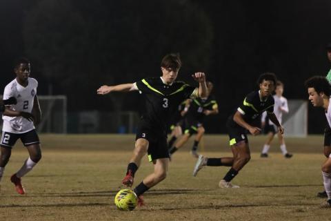 Columbia's Cody Bass dribbles the ball up the field against Gainesville on Jan. 10. (BRENT KUYKENDALL/Lake City Reporter)