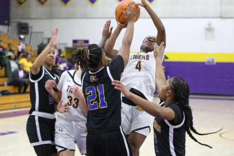 Columbia guard Eriel Baker shoots while defended by Rickards forward Jariyah Jordan (21) and guard Lauryn Pye (3) on Thursday night. (BRENT KUYKENDALL/Lake City Reporter)