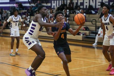 Columbia guard Shaheed White drives to the basket while defended by Gainesville forward David Osho on Thursday. (BRENT KUYKENDALL/Lake City Reporter)