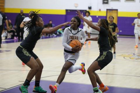 Columbia guard Ayesha Broxey drives to the basket while defended by a pair of Oakleaf players on Tuesday night. (BRENT KUYKENDALL/Lake City Reporter)
