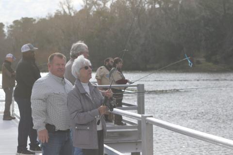Columbia County Commission Chairman Tim Murphy assists Rose Pavey in casting her line off the new Harter Pier at Lake Montgomery on Friday afternoon. The pier officially opened Friday during a ribbon cutting ceremony. (TONY BRITT/Lake City Reporter)
