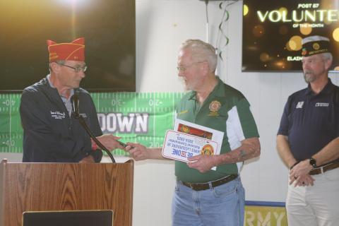 William ‘Bill’ Huggins, American Legion Post 57 Commander, receives mementos from James A. LaCoursiere, the national commander of the American Legion, during his visit to Post 57 on Monday. (TONY BRITT/Lake City Reporter)