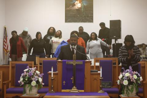 Rev. Jon A. Ingraham, pastor of New Mt. Pisgah AME Church, leads a  prayer during the MLK service on Monday morning. (TONY BRITT/Lake City Reporter)