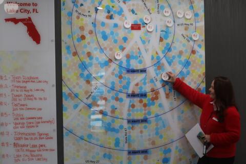 Lynn Branscome, TownePlace Suites general manager, adjusts icons on the visitors to Lake City map in the hotel’s lobby. The hotel opened just a few weeks ago at the U.S. Highway 90 and Interstate 75 interchange. (TONY BRITT/Lake City Reporter)