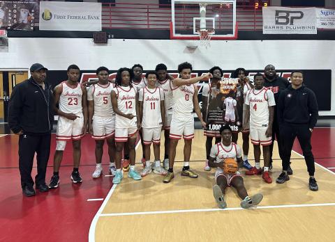Fort White’s boys basketball team celebrates Jaydan Jackson’s 1,000th career point following Thursday’s win over Bronson. (COURTESY)
