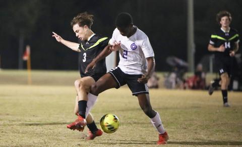 Columbia’s Cody Bass (left) and Gainesville’s Adebayo Bello-Roufai (2) battle for possession of the ball on Friday night. (BRENT KUYKENDALL/Lake City Reporter)
