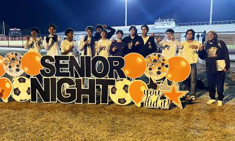 Columbia’s boys soccer team poses with Orange Park’s Senior Night sign after defeating the Raiders 2-0 on Friday. (COURTESY)
