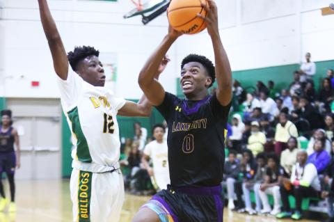 Columbia guard Murkail Cray drives to the basket while defended by Suwannee guard Khy Smith on Friday. (PAUL BUCHANAN/Lake City Reporter)