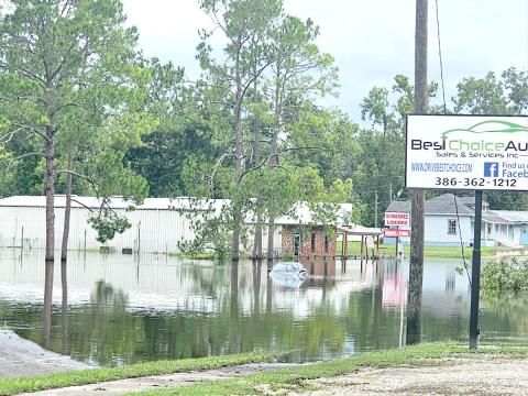 A car sits submerged in flood waters on Ohio Avenue (U.S. Highway 129) in Live Oak following Hurricane Debby in August. (FILE)
