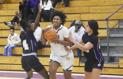Columbia forward Jolena Gardner tries to split a pair of Gainesville defenders Friday night. (MORGAN MCMULLEN/Lake City Reporter)