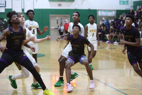 Columbia forward Zavian Douglas (13) and guard Murkail Cray (0) eye a rebound and box out Suwannee while guard Shaheed White (4) also rushes in for a rebound last Friday. (PAUL BUCHANAN/Lake City Reporter)