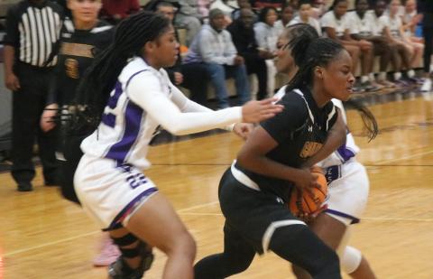 Columbia guard Eriel Baker is double teamed by Gainesville's Mayah Gordon (22) and Lady Taylor during Tuesday night's 53-27 loss. (JORDAN KROEGER/Lake City Reporter)