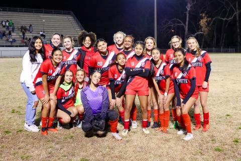 The Lafayette girls soccer team poses with the District 2-2A championship trophy after defeating Branford 1-0 on Tuesday night. (JACK HOWDESHELL/Lake City Reporter)