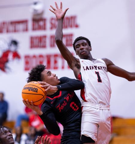 Fort White guard Tafari Moe tries to get off a shot while defended by Lafayette guard Jordan Murphy on Dec. 5. (JACK HOWDESHELL/Lake City Reporter)